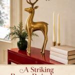 Brass Reindeer Books and Candle on Red Wood Table