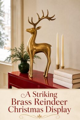 Brass Reindeer Books and Candle on Red Wood Table
