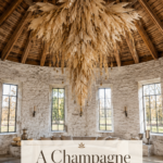 Refined Thanksgiving barn with cascading ivory harvest chandelier pale pumpkins and aged silver vessels