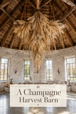 Refined Thanksgiving barn with cascading ivory harvest chandelier pale pumpkins and aged silver vessels