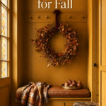 ochre boot room for fall with copper leaf wreath cognac cushion and layered autumn textiles