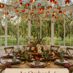 Fall greenhouse tablescape beneath glowing apple lanterns with an orchard centerpiece and a warm editorial title panel