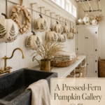 Botanical fall laundry room with fern patterned pumpkins pale wreath woven baskets and dark soapstone sink