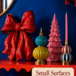 small holiday console display with bold ceramic decorations and warm headline panel