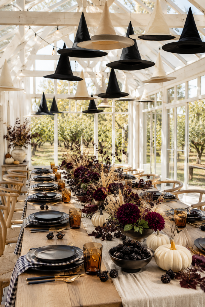 Blackberry Harvest Table Beneath Floating Witch Hats
