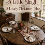 Cottage Christmas dining table with mixed patterned dishes and a sleigh centerpiece beneath text reading A Little Sleigh A Lovely Christmas Table