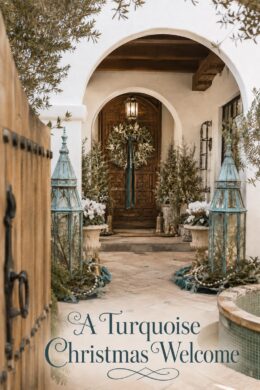 Christmas courtyard with turquoise lanterns beside terracotta paving and an arched wooden doorway with the words A Turquoise Christmas Welcome