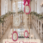 Christmas chalet gallery with ornate portrait ornaments and a pink bow beneath timber beams with text reading Cameo Christmas with a Pop of Pink