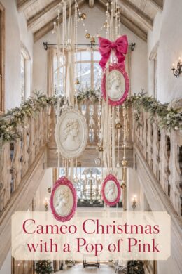 Christmas chalet gallery with ornate portrait ornaments and a pink bow beneath timber beams with text reading Cameo Christmas with a Pop of Pink