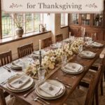 long wood Thanksgiving table with berry stems white pumpkins candlelight and handcrafted place settings