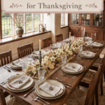 long wood Thanksgiving table with berry stems white pumpkins candlelight and handcrafted place settings