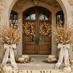 Fall porch decorated with golden pear wreaths ivory pumpkins and ribboned urns beneath text reading A Golden Welcome for Fall
