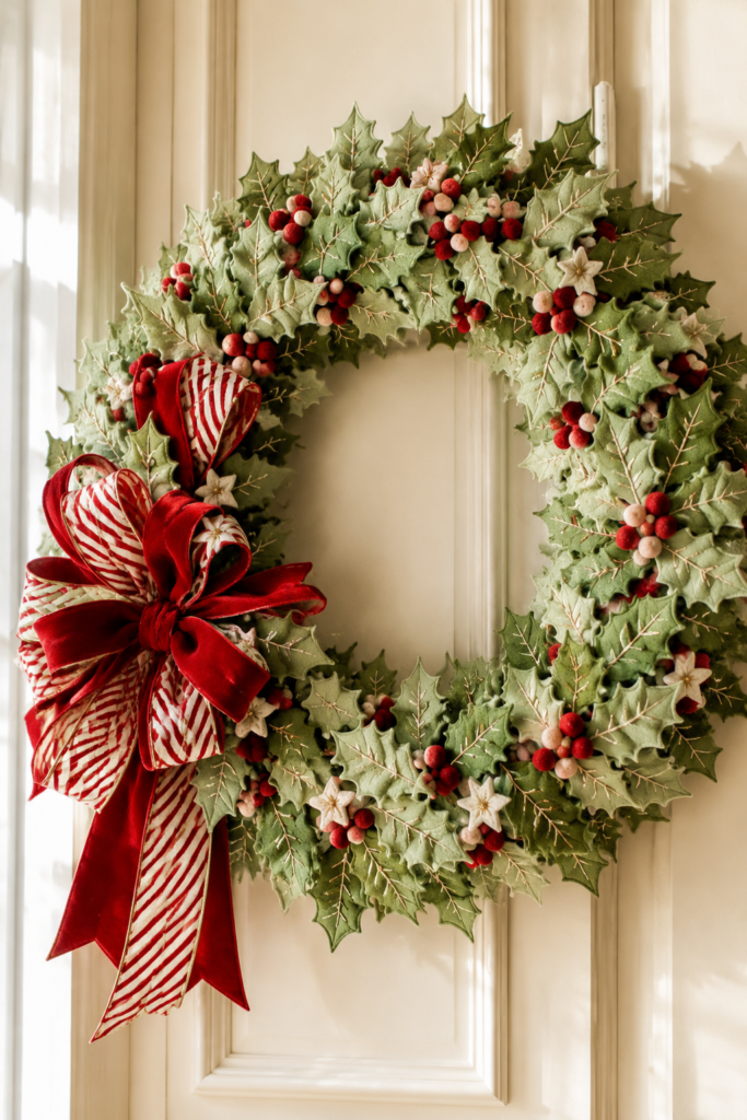 green holly felt wreath with red and white berries and red and white striped bow