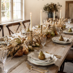 Harvest table with gold flatware and clear stemware beneath text reading Pears and Wheat A Thanksgiving Table to Gather Around
