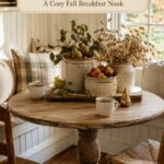 Harvest fruit and cream pottery centerpiece beneath a banner reading Pears and Stoneware A Cozy Fall Breakfast Nook with woven seat chairs in front
