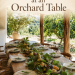 Pear and fig centerpiece on a wooden dining table overlooking leafy trees with text reading Thanksgiving at an Orchard Table