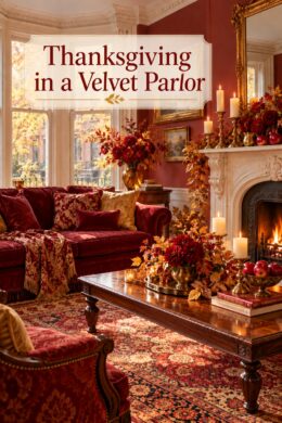 Crimson sofa and red flower arrangements beside a pale fireplace with the words Thanksgiving in a Velvet Parlor