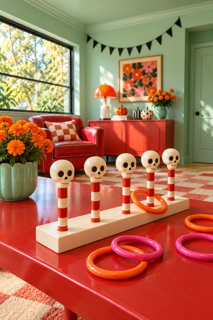 Ivory decorative skulls top candy striped ring toss pegs on a red game table with pink and orange hoops in a mint Halloween room